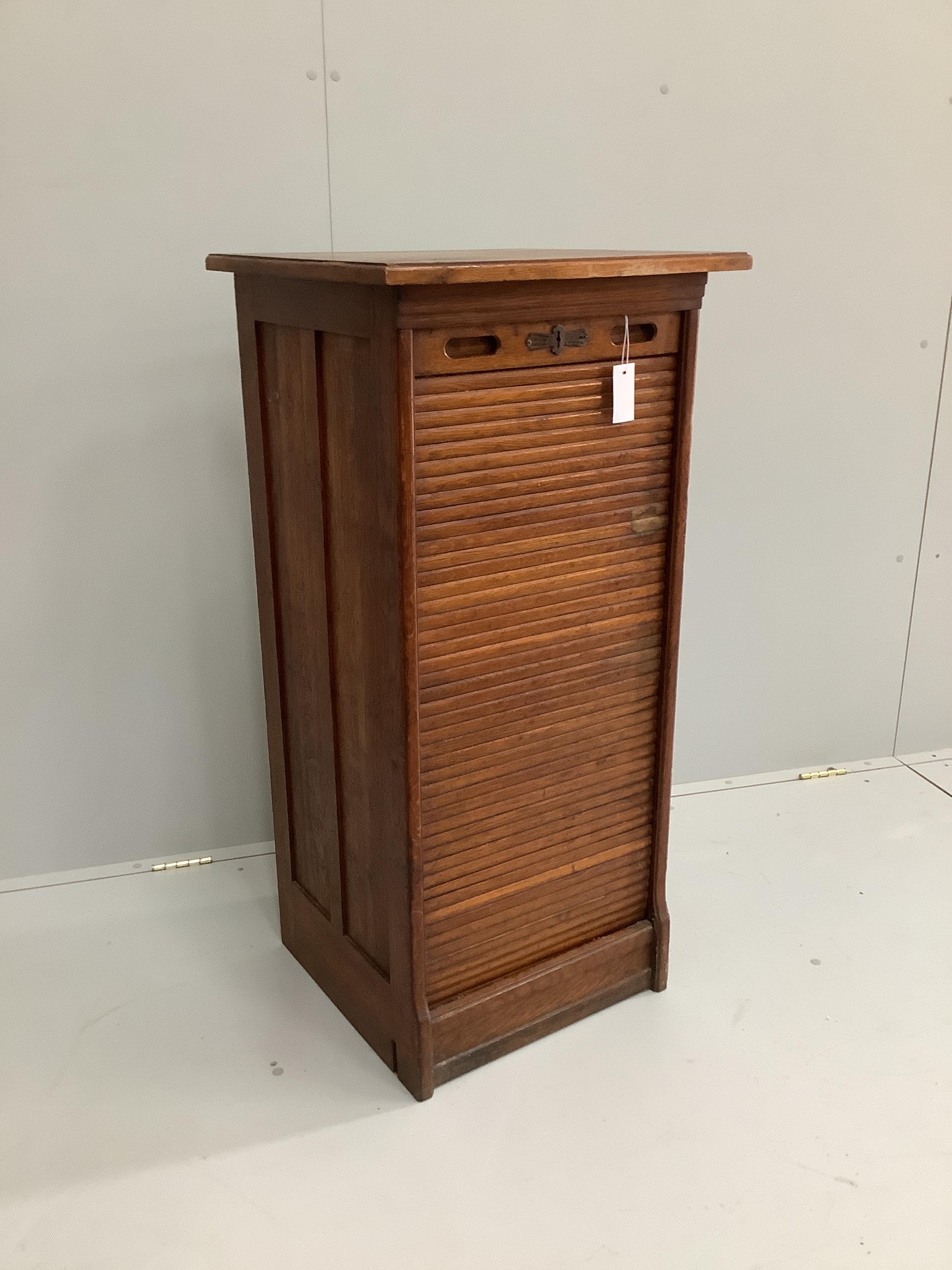 A 1920's oak tambour filing cabinet, width 52cm, depth 48cm, height 109cm